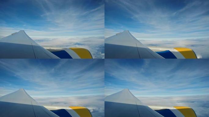发动机机翼飞机在天空和云上的景色很美。在窗口飞机上看到引擎和机翼在云上，天空蓝色或蔚蓝的天空在美丽的