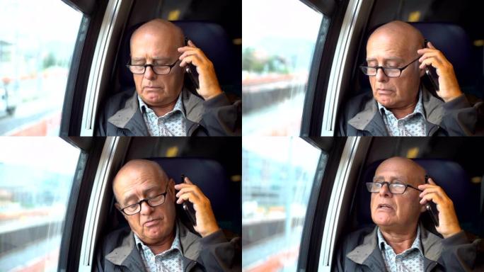 老秃头男子在移动火车内用手机聊天-模型发布
