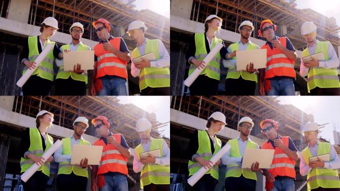 在镜头前，中年人和他的团队多种族一起浏览建筑计划，并讨论下一步的工作。他使用定量配给与建筑物屋顶的工