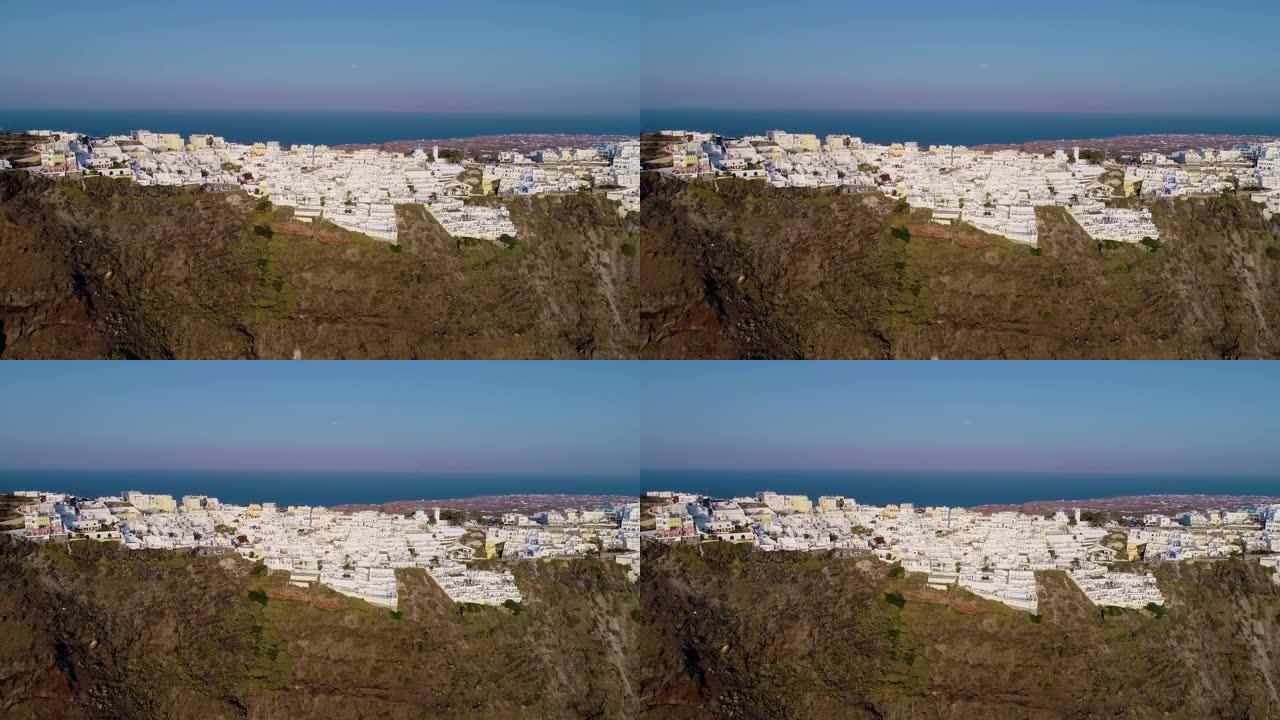 在蓝天下的圣托里尼岛山顶上的一个村庄的鸟瞰图。该城市靠近地中海。