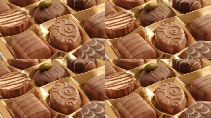 一盒巧克力许多不同的糖果缓慢倾斜4K