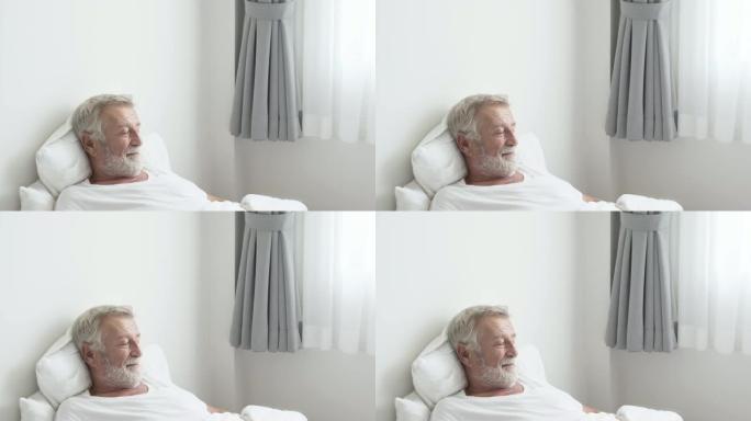 祖父或老人睡在白色房间的床上