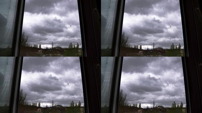 巨大戏剧性的雷暴云在窗外的天空中飞翔