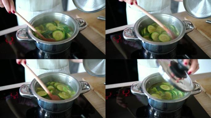 女人的手搅拌西葫芦-制作西葫芦汤