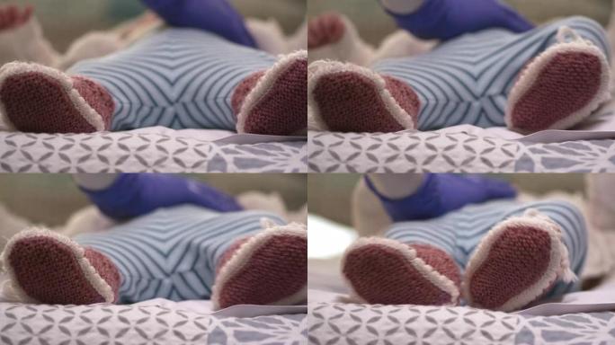 家庭护理员。新型冠状病毒肺炎大流行期间，医生在家里拜访了一名新生婴儿。戴防护口罩预防疾病。