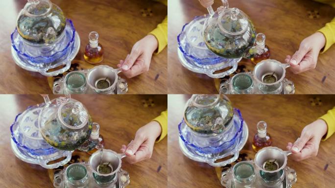 女人将茶壶中的茶水倒入杯中，茶道概念
