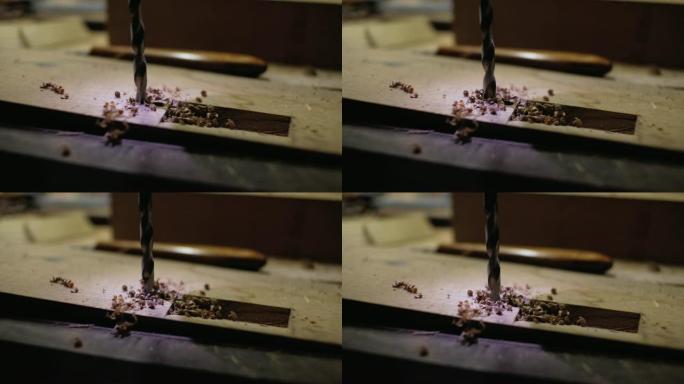 金属钻在木制细节上开了一个洞。背光钻。close-up.4k