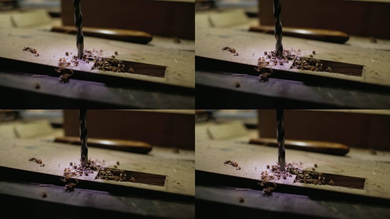 金属钻在木制细节上开了一个洞。背光钻。close-up.4k