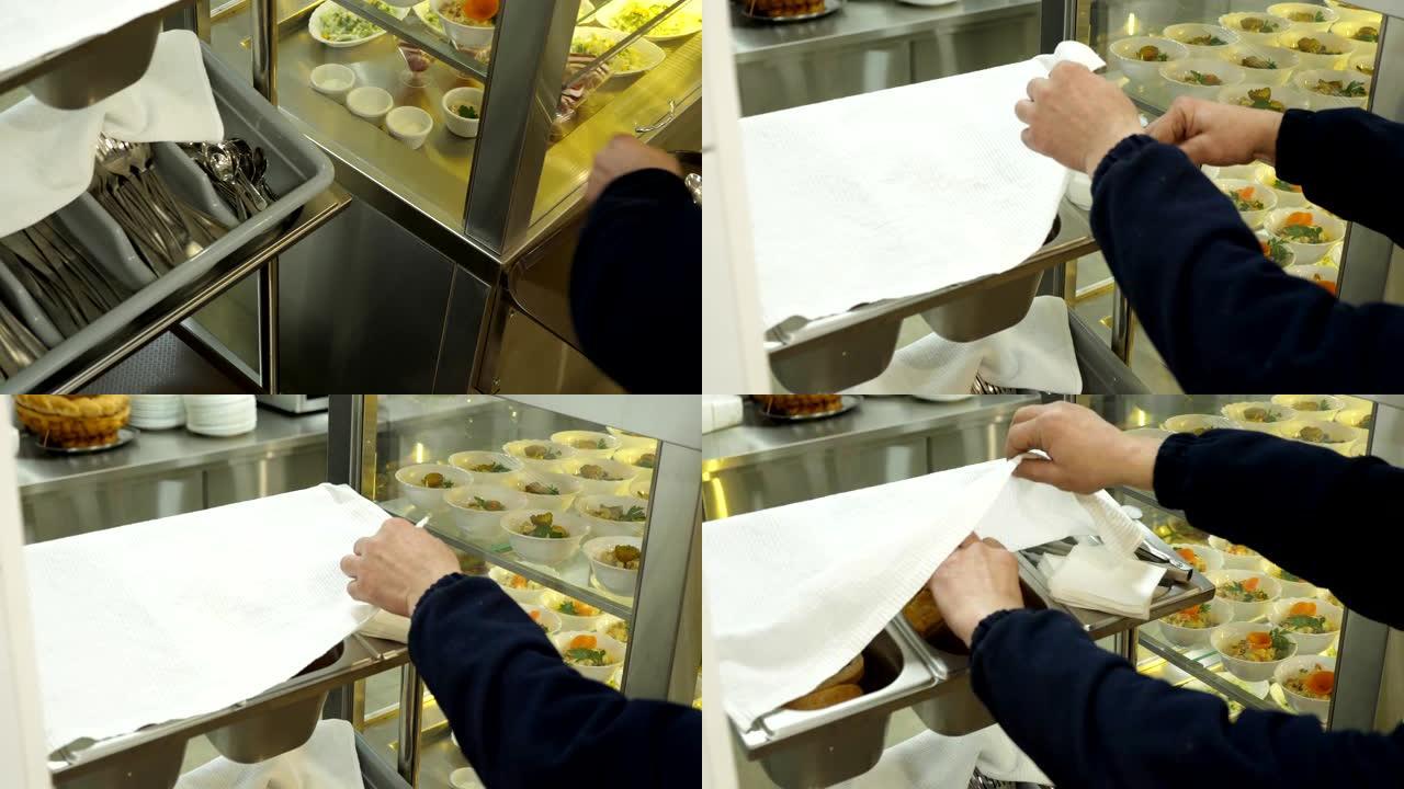 特写，工人的手在自助食堂拿面包，餐具，餐巾纸