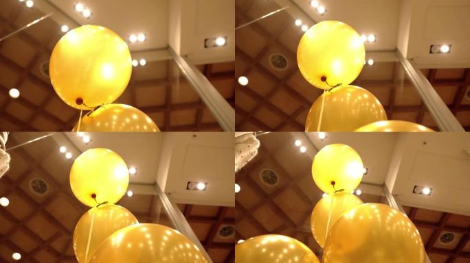 商店里穿着女装的人体模型附近的黄色气球