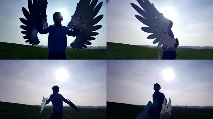 带着天使翅膀的草地上的男孩