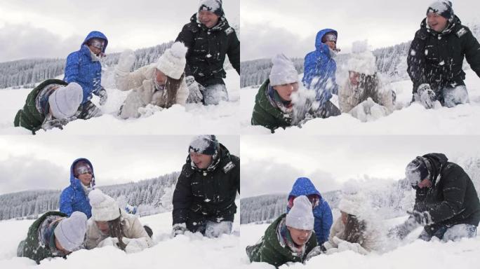 一群朋友兴高采烈地互相撒雪。美好的冬日。在白雪皑皑的森林背景下