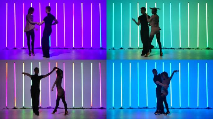 热情的年轻女子和她的伴侣在明亮的彩色霓虹灯上跳舞伦巴。一对美丽的舞者在慢动作中运动的剪影