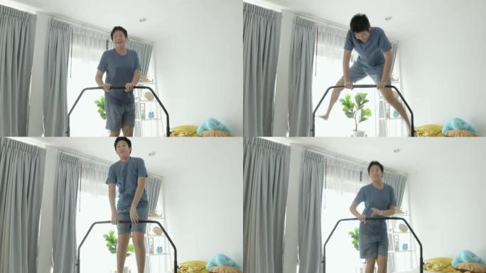 快乐的亚洲男孩跳上迷你蹦床在家附近的窗户，呆在家里活动理念。
