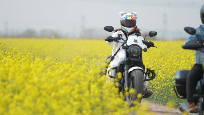 摩托车在千亩油菜花田的小路上骑行