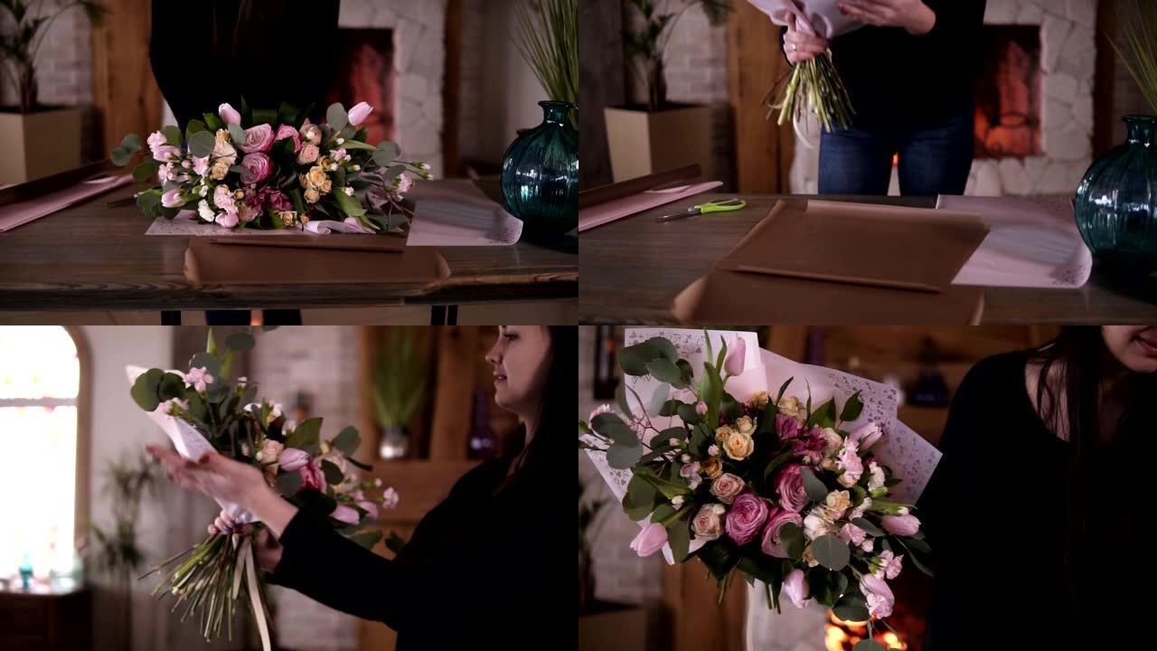 职业女性花卉艺术家，花店在家庭工作室工作室的礼品纸上包装鲜花-粉色玫瑰。花艺、手工制作和小型企业概念