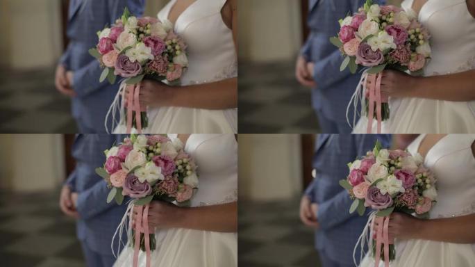 新娘手中的婚礼花束。婚礼当天。慢动作