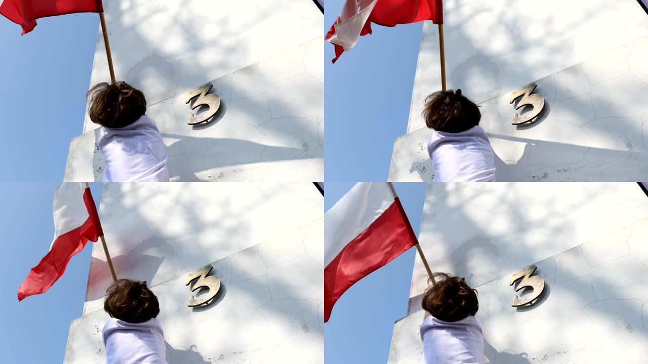 这个男孩正在悬挂一面旗帜。波兰5月3日国庆日，宪法日