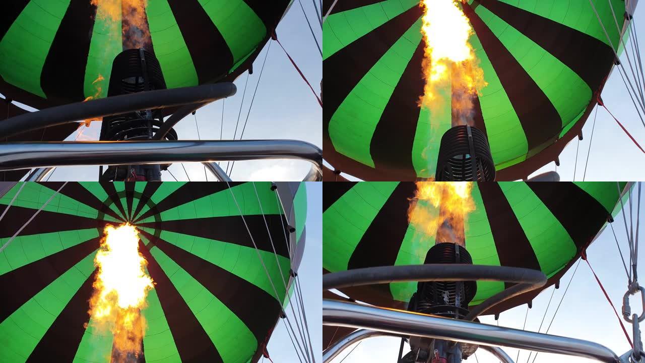 热气球西瓜冒险。燃烧器将火焰引导到信封中。由于热空气，飞机在早晨的蓝天中飞行。