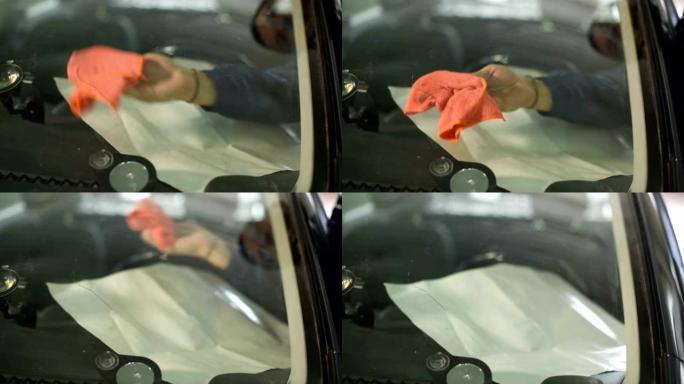一名男子的特写镜头专业消除汽车挡风玻璃上的裂缝