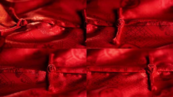 接近纹理和结或纽扣男性红色旗袍
