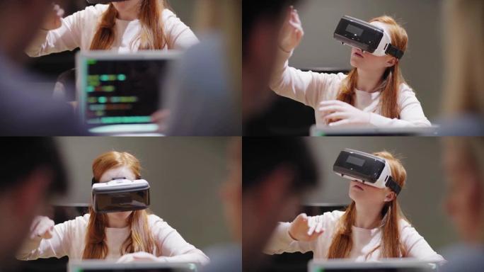 相机从带有代码的笔记本电脑倾斜到年轻女子，在办公室进行VR应用测试时在开发人员附近探索虚拟现实