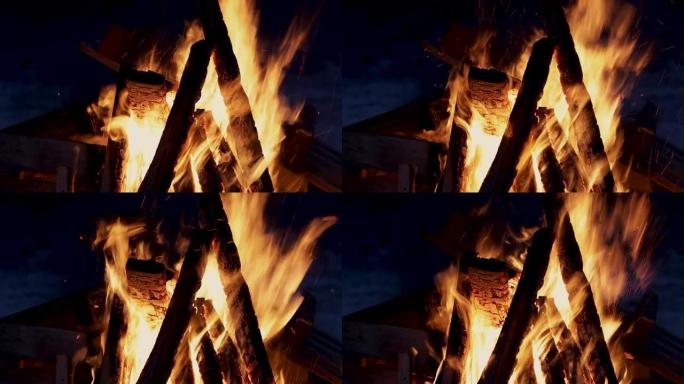 晚上和燃烧的火。篝火。黑色背景上燃烧的火焰特写，燃烧的木头的寂静和crack啪声。