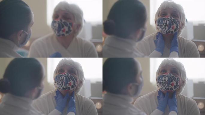 家庭护理员。一位医生对一位高级女性进行体检的特写镜头。在新型冠状病毒肺炎大流行期间，医生在她的家中拜