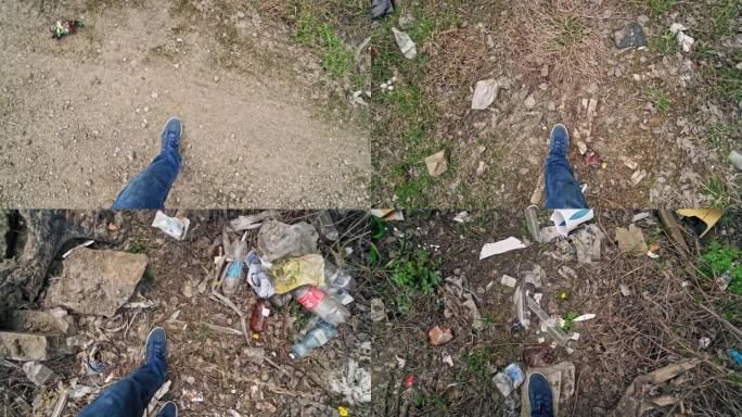 穿着牛仔裤和运动鞋的男人的腿带着很多垃圾沿着肮脏的地方行走。