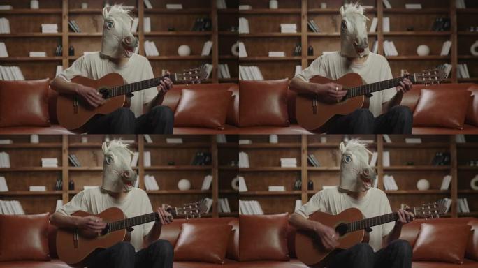 独角兽头弹吉他的人。有趣的音乐播放。独角兽坐在沙发上弹吉他。
