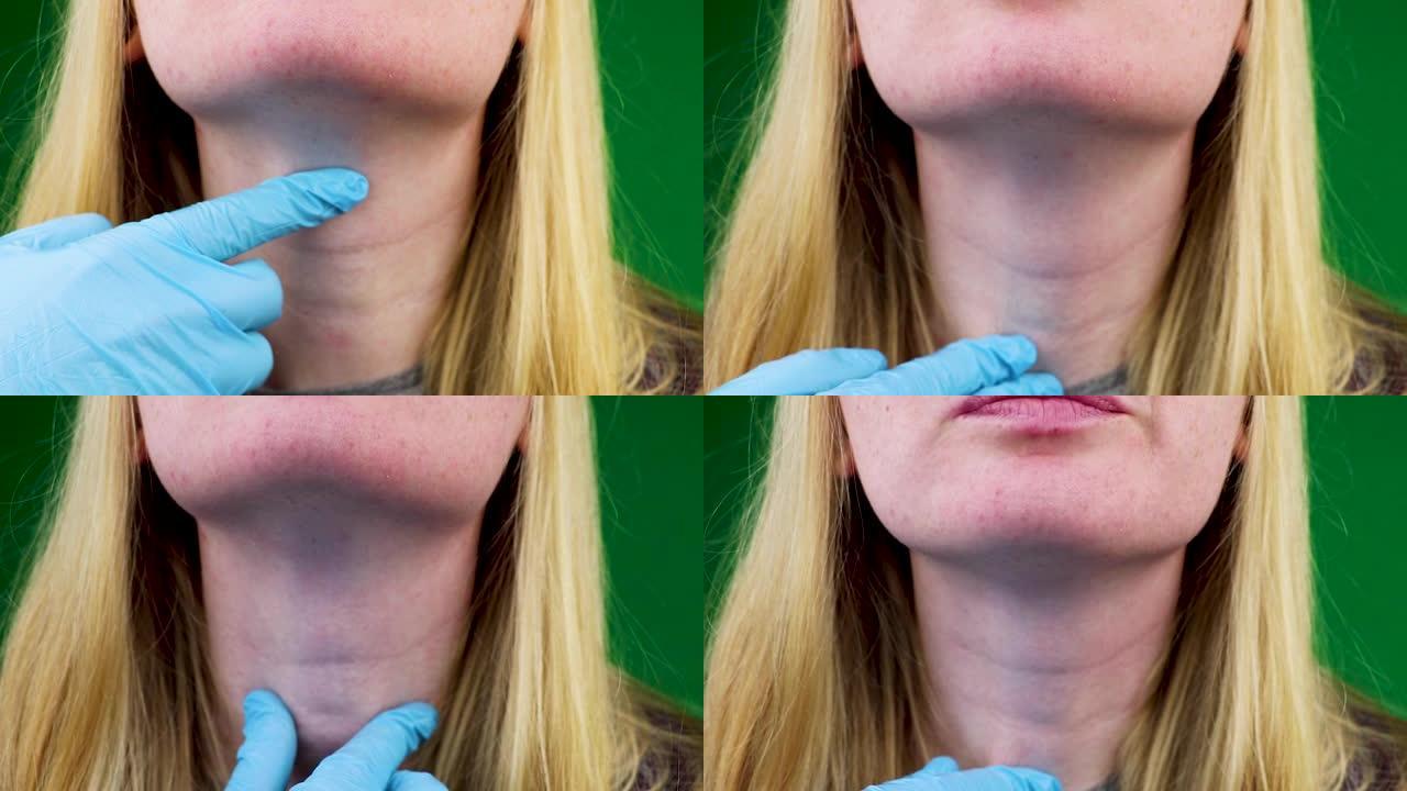 甲状腺和喉咙的触诊。由医生检查。绿色背景。绿色背景