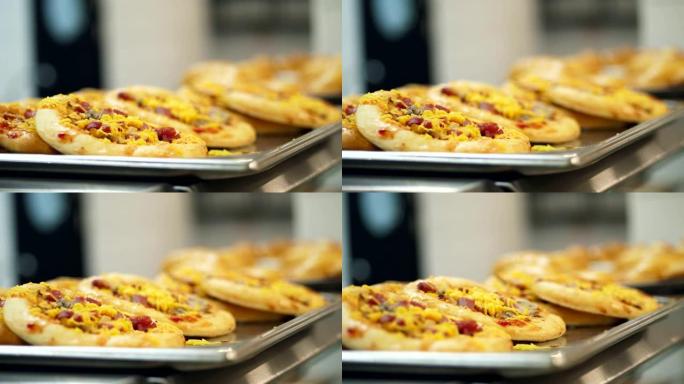 特写镜头，展示迷你披萨，现代食堂的酵母面团烘焙