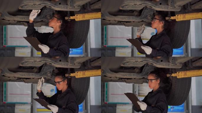年轻的修理工在轮胎店检查汽车轮胎的状况。