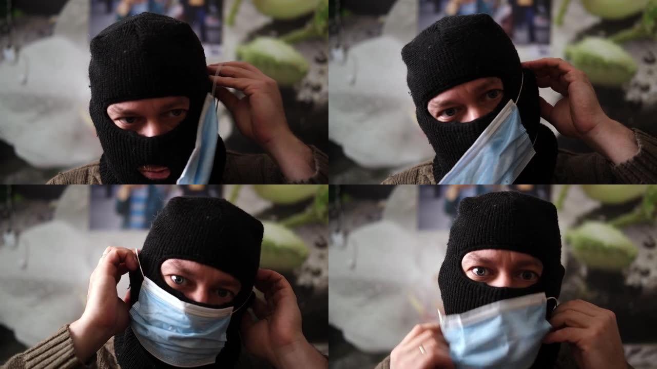 一名戴着防盗面具的男子试图戴上医用面具。