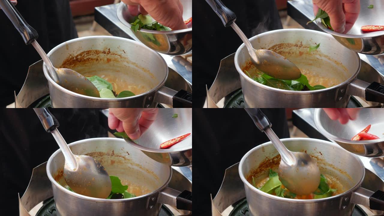 一步一步煮汤姆山药汤。辣辣椒和香草被添加到煮沸的汤中。泰国菜。特写。4k