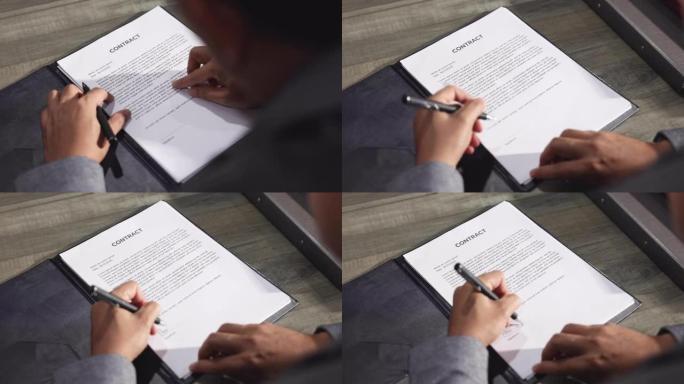 商人在达成共同协议后签署商业文件合同。