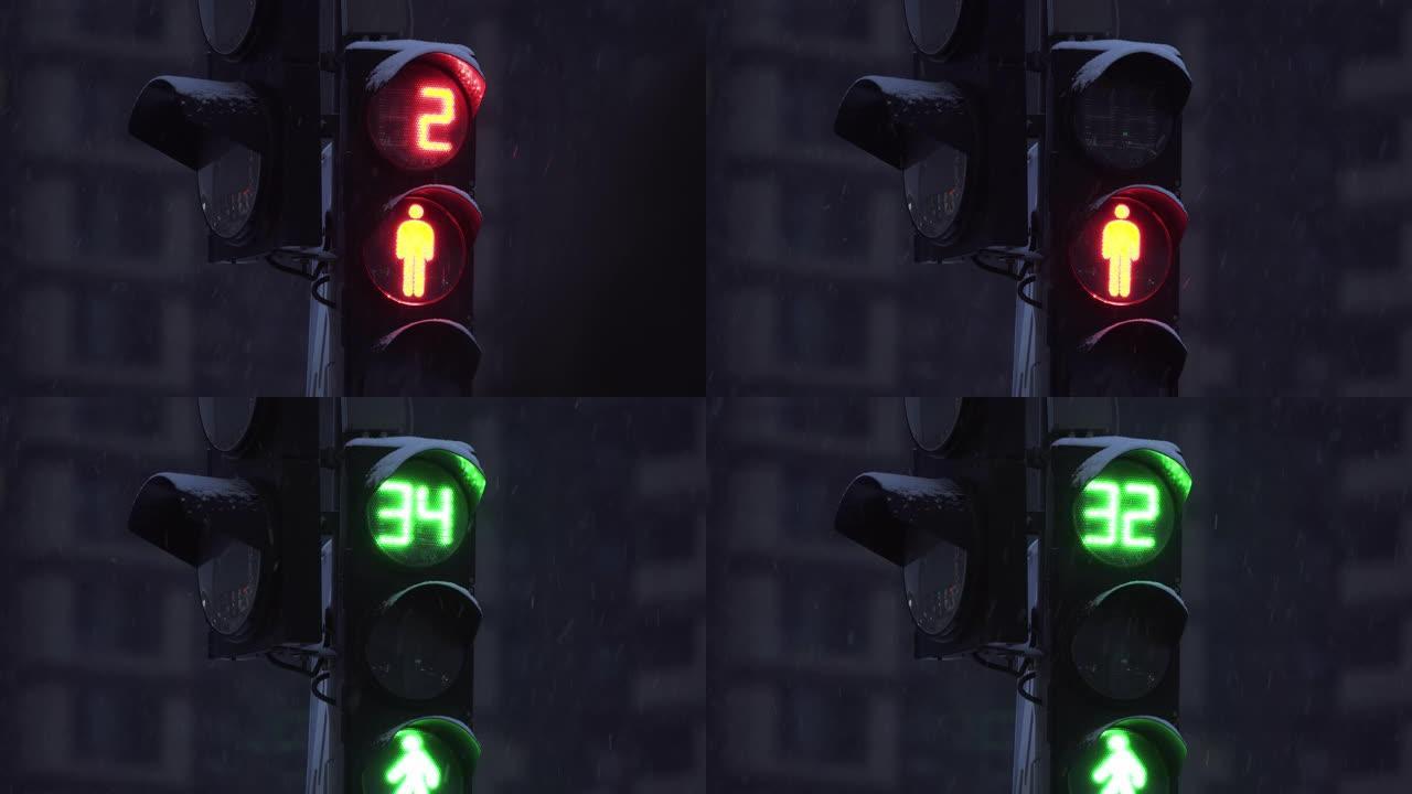 降雪时，傍晚城市街道上的交通信号灯。特写。冬季建筑物背景上的交通信号灯