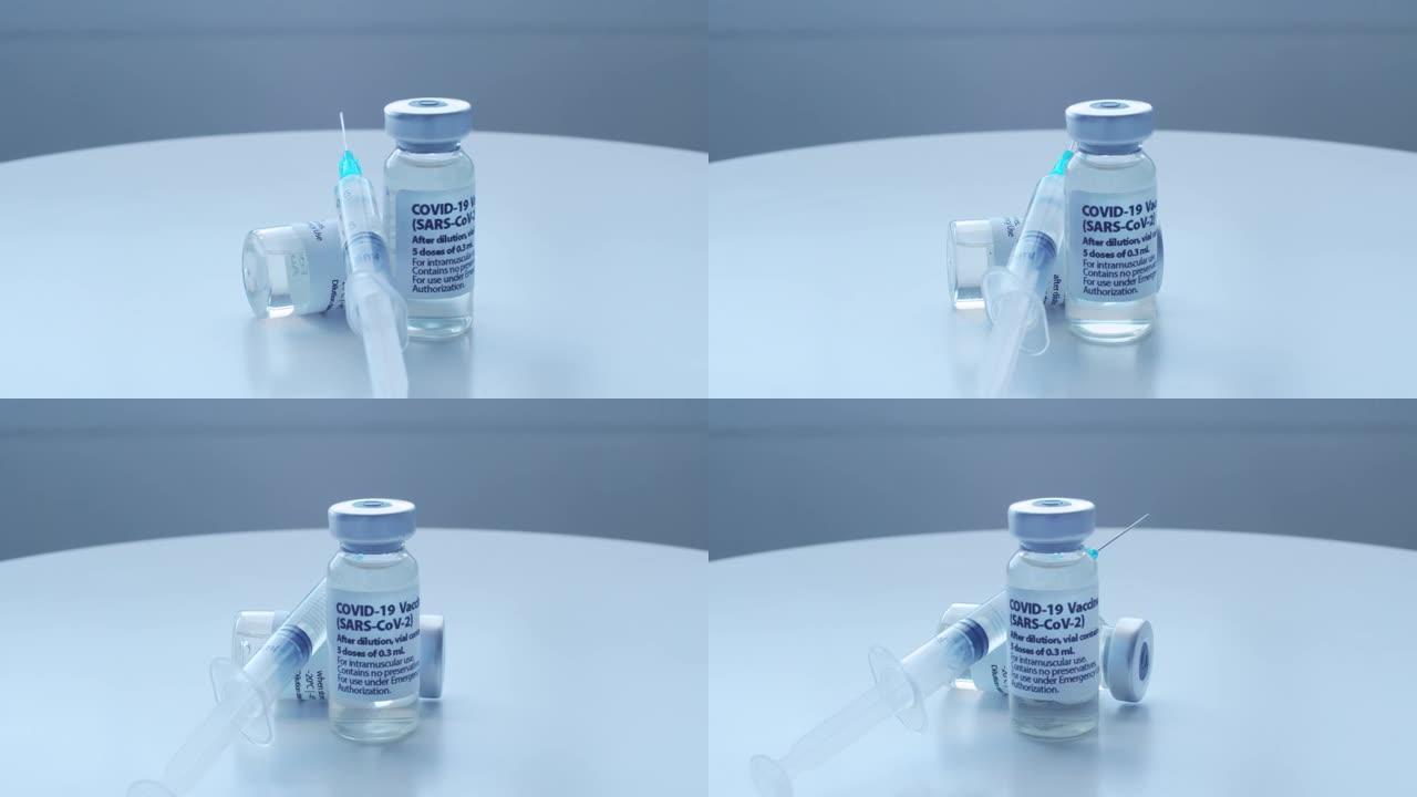 一台旋转摄像机在白色的桌子上拍摄Covid-19疫苗。概念:预防冠状病毒。