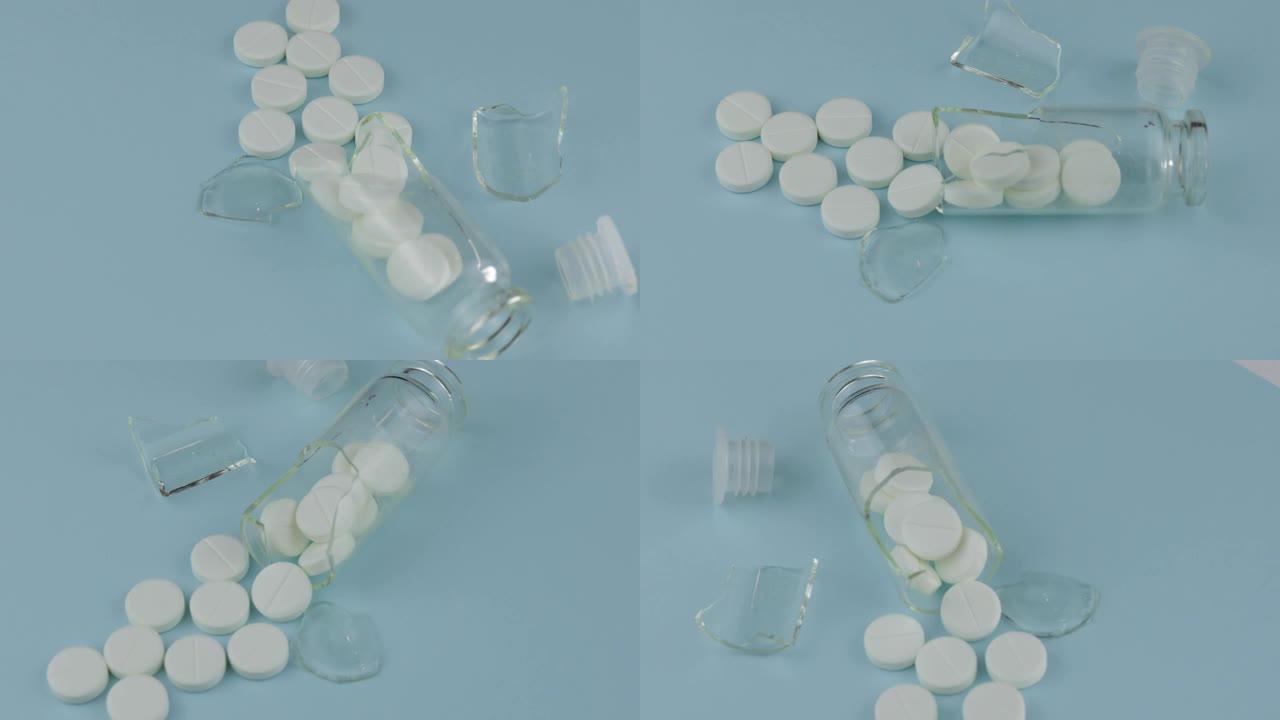 碎玻璃罐子里有许多药丸和药物在蓝色背景上旋转