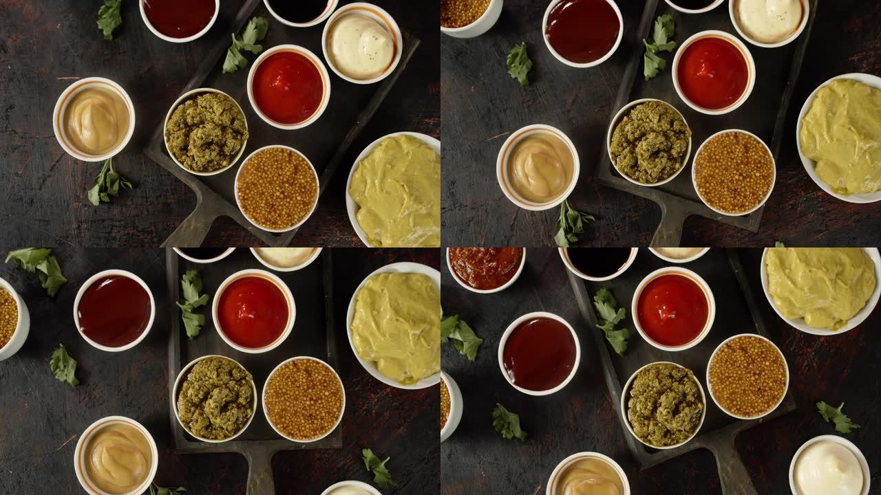 不同类型的调味汁在切菜板上旋转。