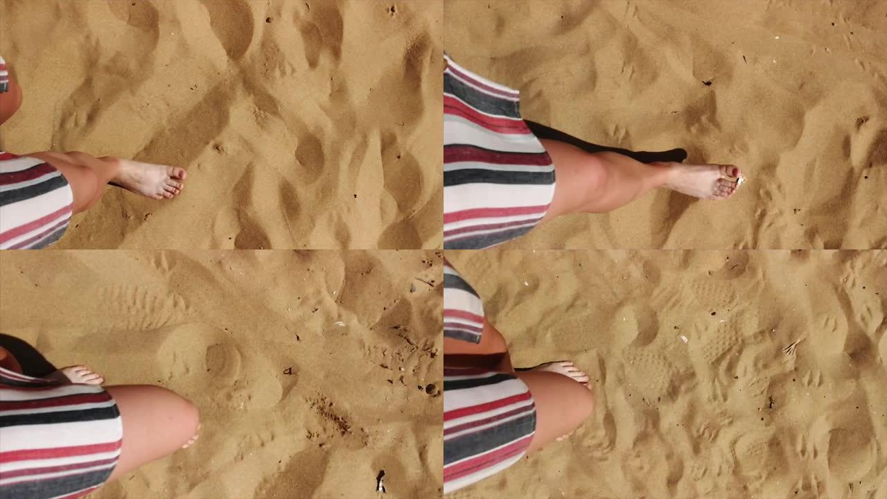 露脸女性赤脚行走在沙滩上的俯视图