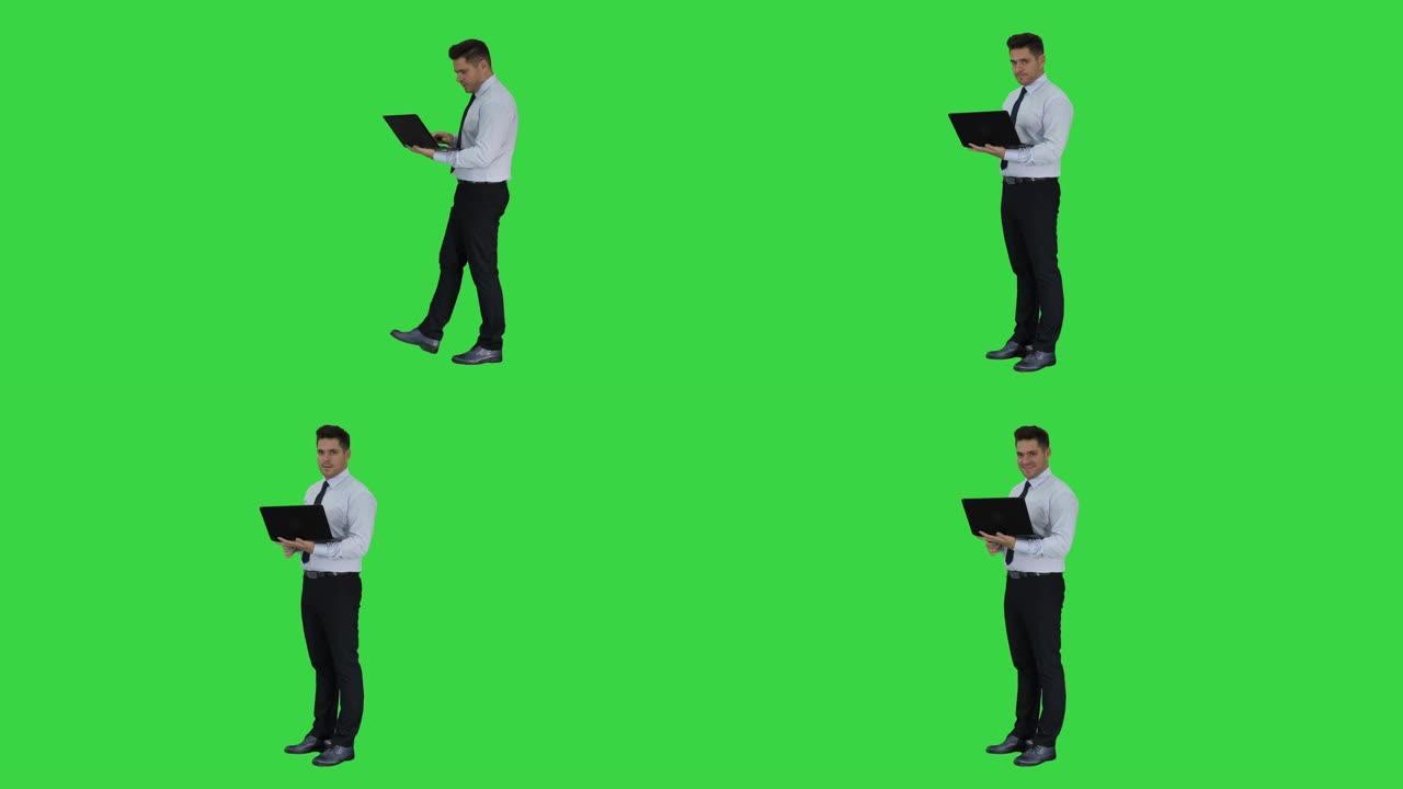 商人按下播放按钮在绿色屏幕上启动或启动项目或笔记本电脑上的演示，色度键