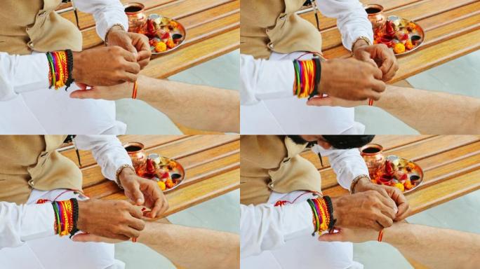 印度教牧师在崇拜者的手腕上绑上圣线