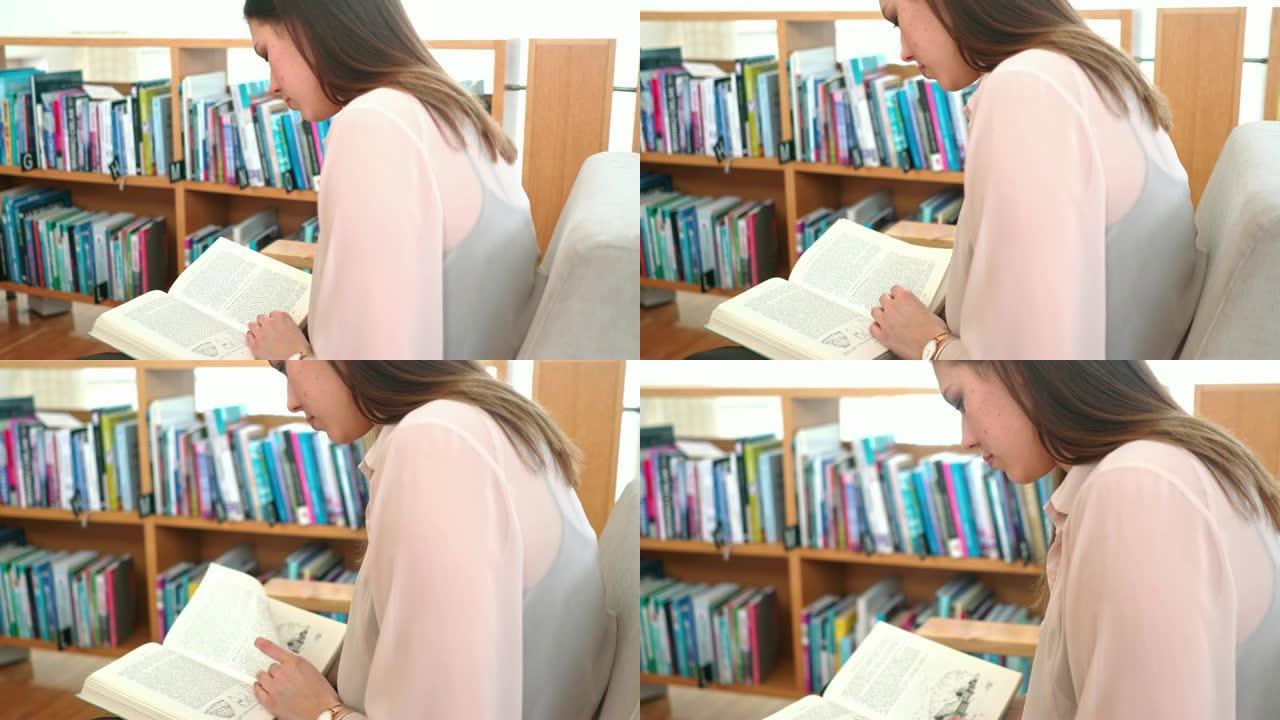 女学生在图书馆读大学历史书