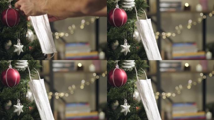 在圣诞树上悬挂白色医用面膜作为装饰品。