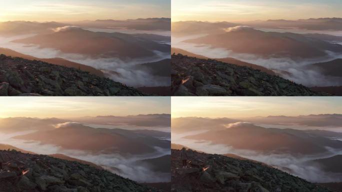 山景与晨雾和女孩站在山顶的黎明。