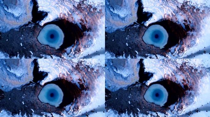 一架无人驾驶飞机的美妙鸟瞰图，它离冰岛盖西尔的geuser中心越来越远。烟雾从间歇泉中散发出来，人们