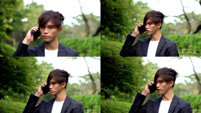 跟踪镜头-年轻的亚洲男子在智能手机上聊天