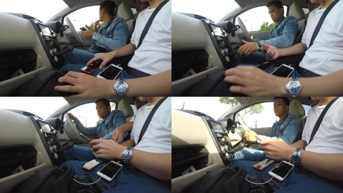 四个年轻人乘智能手机浏览汽车的应用程序