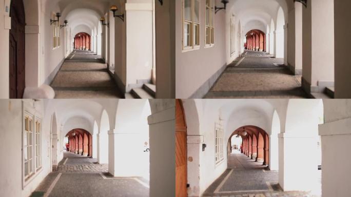 布拉格的拱形城市通道。带相机的人的步数平稳移动。
